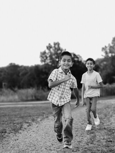 brothers running in park park for family photoshoot at westcreek reservation parma ohio cleveland family photography