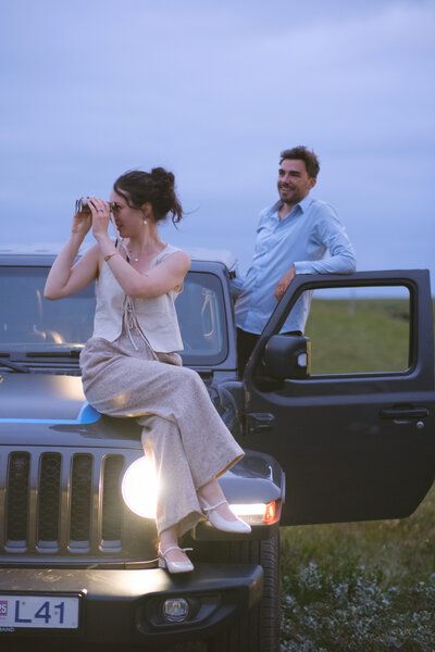 bride in a glittery white dress and groom holding hands