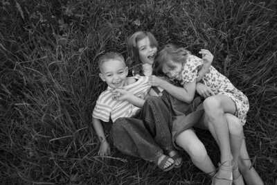 Kids laughing and playing in the grass