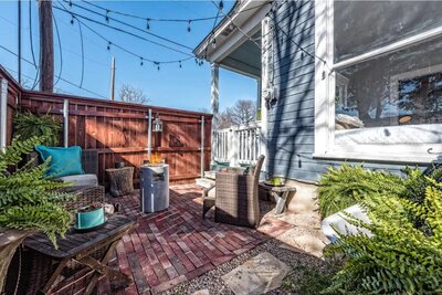 Covered parking for two, a large covered deck, and small yard complete with patio at  this 2-bedroom 2-bathroom vacation rental home on the Baylor University campus in Waco, TX