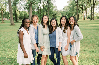 six girls at a park smiling at the camera