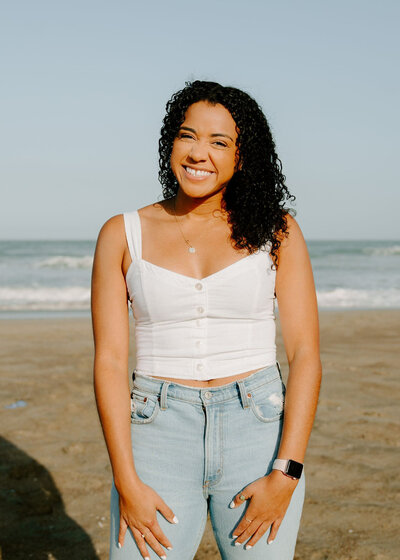 woman at beach smiles
