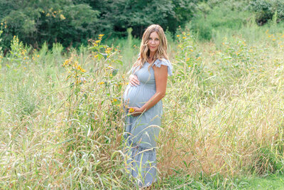 Outdoor maternity session in the tall grass field.