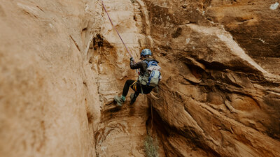 Person climbing a rock in Utah