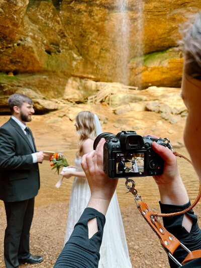 Desiree taking photos of an eloping couple.