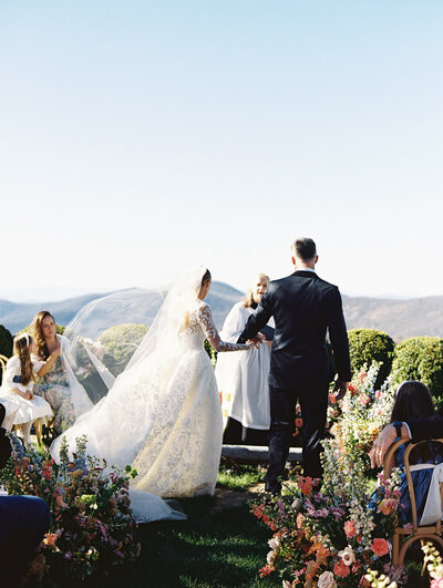 a groom stomping glass and the bride cheering at their wedding at Ashbourne Farms