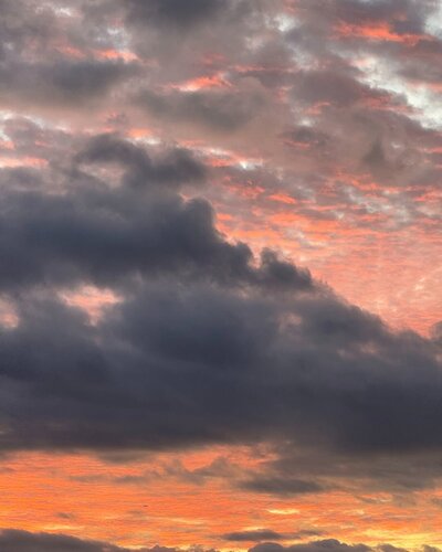 purple and pink sunset with fluffy clouds