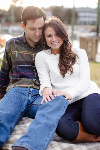 Engaged couple leans on one another during Bald Head Island engagement session.