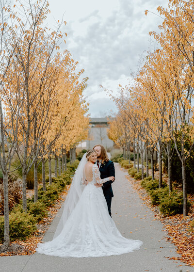 A bride and groom on a pathway at Fredrick Meijer Gardens taken by  a Grand Rapids wedding photographer