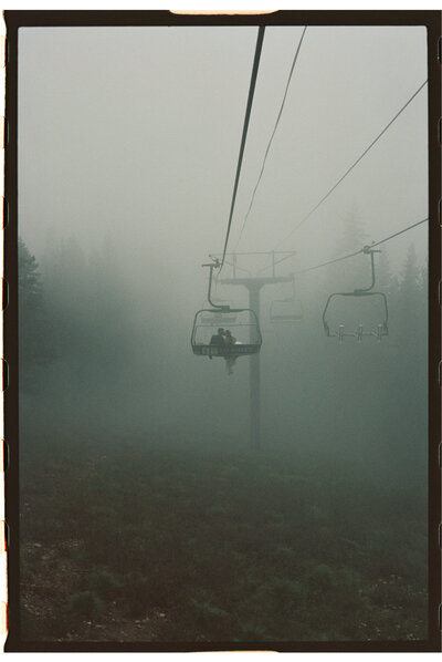 film photo of bride and groom on chairlift