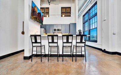 Bar height seating for four in the kitchen of this one-bedroom, one-bathroom downtown luxury rental condo in the heart of Waco within walking distance to Waco's most popular shops, eateries & museums.