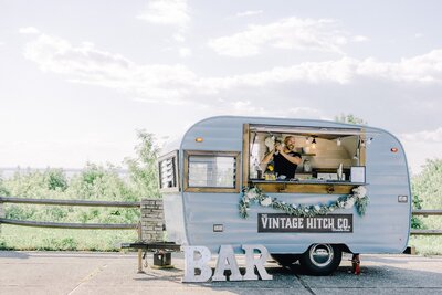 A mobile bar trailer with a sign that says Vintage Hitch Co.