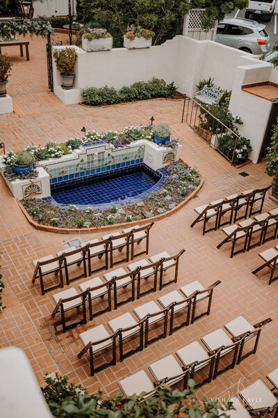 photo of wedding ceremony with lines of chairs and aisle