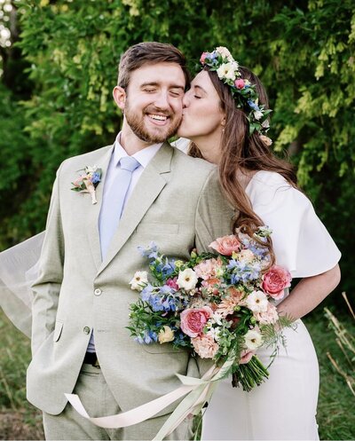 bride holding blue and white bridal bouquet