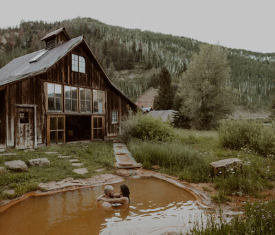 Couple swims at the Dunton Hot Springs