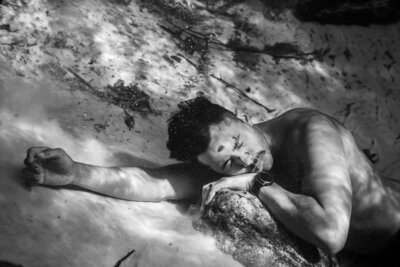 Black and white photo of man underwater