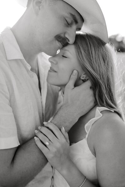 couple holding each other during a pecan grove couples session in college station