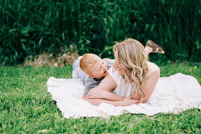 a mom and young son laying on a blanket in a rio, wi motherhood portrait session 