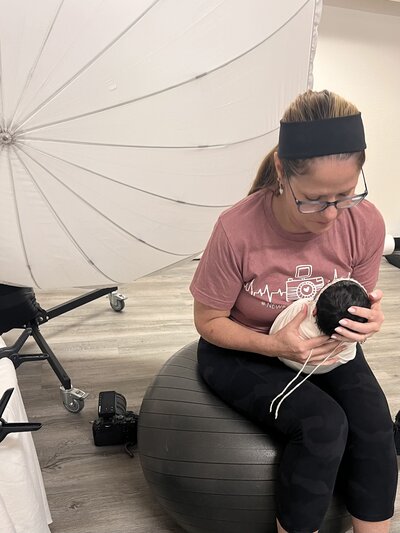 Behind the scenes with the photographer during a newborn photoshoot.