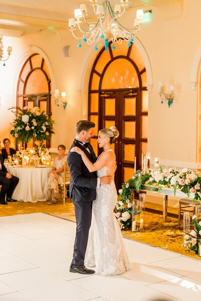 Married couple's wedding dance in white dance floor