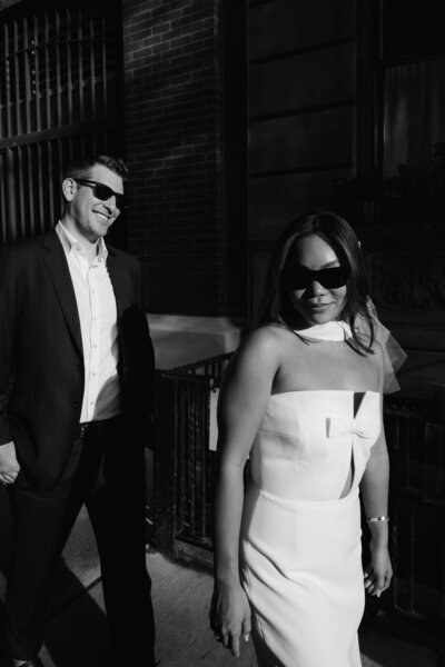 newlyweds walking with sunglasses