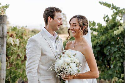 A bride and groom with a white bouquet getting married at Balgownie Estate