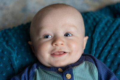 Baby Finnegan smiling at the camera.
