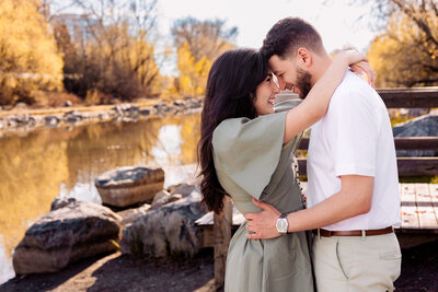 A newly engaged couple put their foreheads together and smile