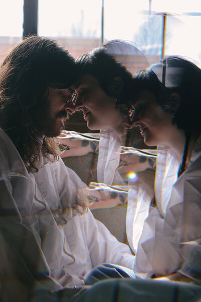 Tattooed couple sharing a candid moment during their alternative wedding in Springfield, MO, photographed by Chelsea Stanford.