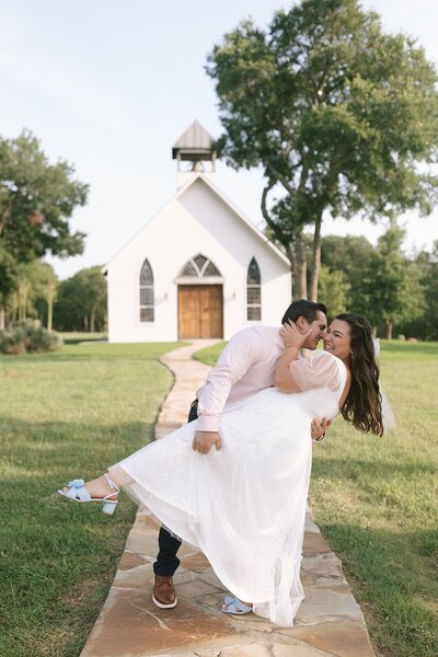 Makayla Rivera's husband dipping her outside of a white chapel