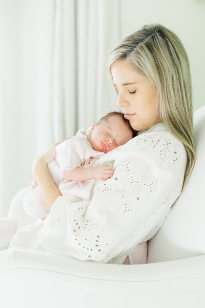 Newborn baby girl in Greenville, North Carolina with mother holding her