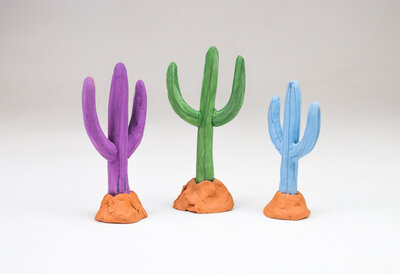 a saguaro cactus shaped ring holder made out of ceramic