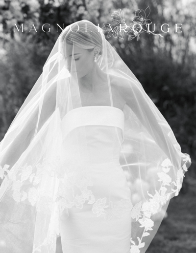 Bride with her veil draped over her head, creating a soft and dramatic silhouette.