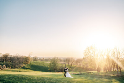 Bride and Groom hold hands while walking back down the aisle at The Stables at Copper ridge in denison iowa. Photo by Anna Brace who specializes in Omaha Ne wedding photography