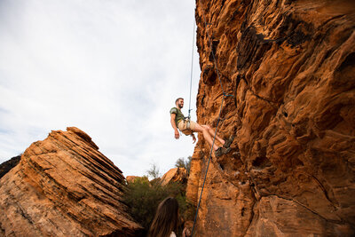 James rappelling down a  mountain side in Sothern utah