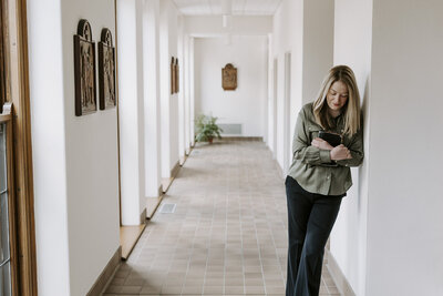 Amanda holding a Bible while standing in the hallway of a church