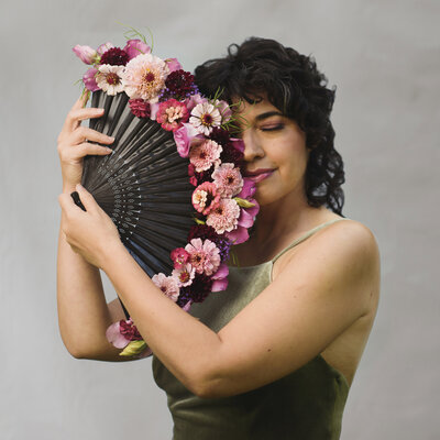 Model holding a flower fan  - photo by Helene Cyr - Fleuris Studio & Blooms