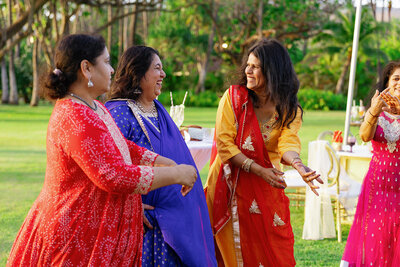 Wedding guests in colorful outfits laughing together 
