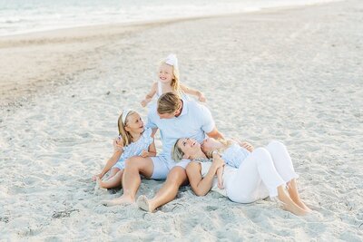 emerald isle beach photographer with family laying down with toddlers