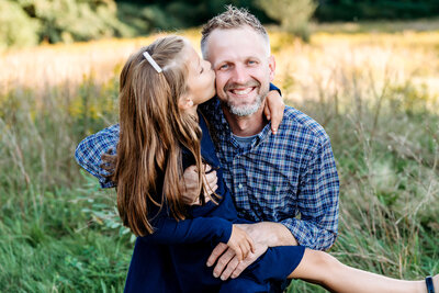 Father and daughter sharing tender moment during golden hour portrait session with Connecticut family photographer