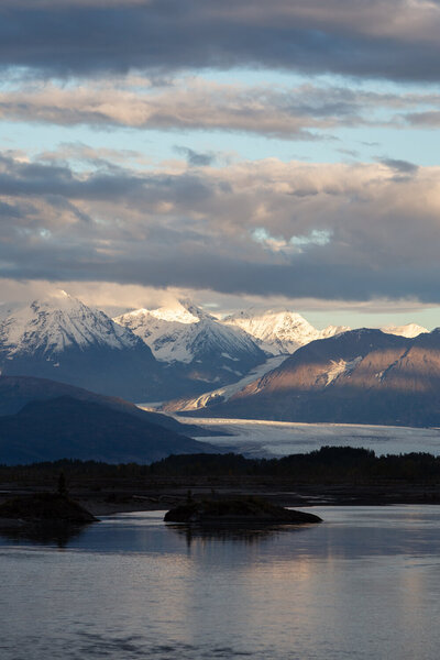 A scenic photo of Valdez, Alaska with snowy glaciers in the background.
