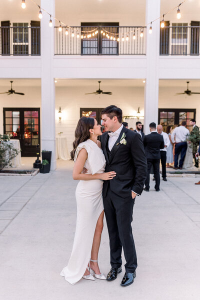 wedding couple posed in front of Texas wedding venue