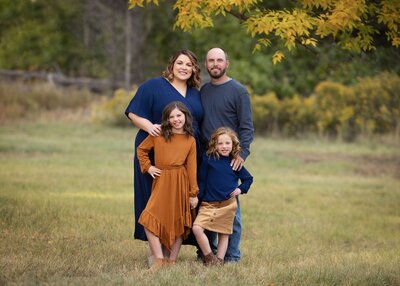 family standing in a field