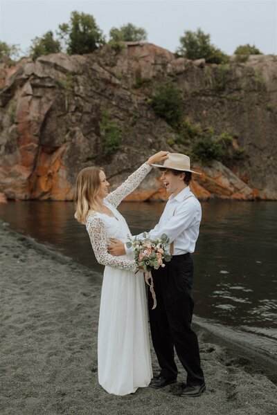 bride places a hat on groom