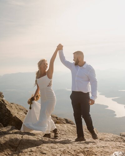 Celebrating their elopement on top of Whiteface Mountain in Lake Placid.