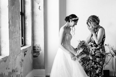 Bride tears up looking at her daughter in wedding dress by winx photo tennessee wedding photographer