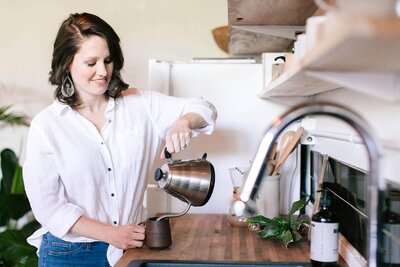 caitlyn gray systems strategist pouring coffee