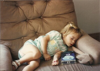 A little girl sleeping on the couch