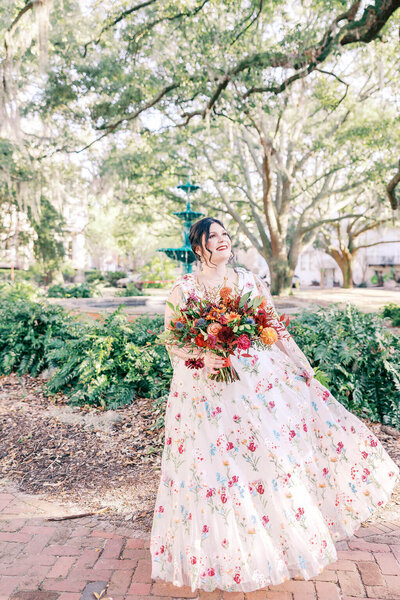Bride holding a bright bouquet during a Savannah elopement under oak trees