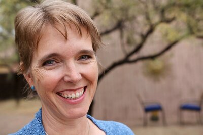 Lori Harger, nurse practitioner, energy healer, and founder of Nurses Healing Nurses is smiling at the camera